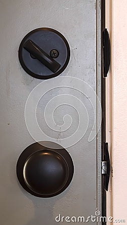 Vertical frame Close up of black door knob and unlocked latch Stock Photo