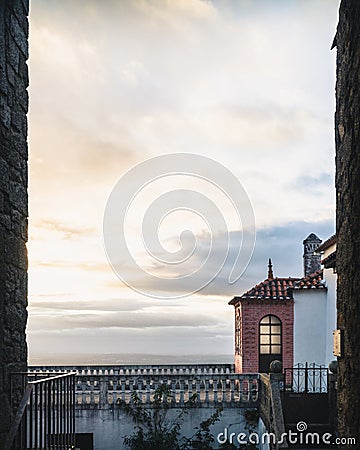 Vertical frame in a frame shot of a balcony with concrete balusters and a cloudy horizon Stock Photo