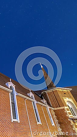 Vertical frame Vivid blue sky over a church in Provo Utah with brick wall and arched windows Stock Photo