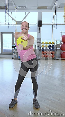 Vertical, full growth. funny bald man doing fitness in the gym Stock Photo