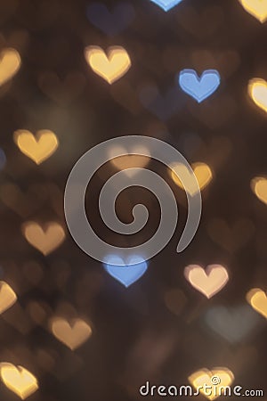 Vertical golden bokeh hearts background. Stock Photo