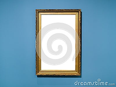 Vertical golden wood picture frame on blue wall Stock Photo