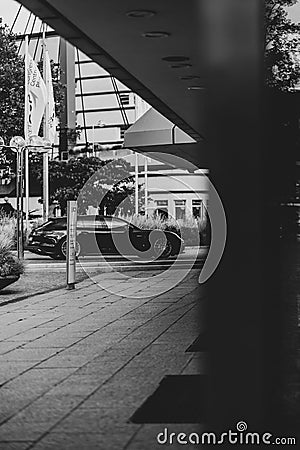 Vertical grayscale of a black car parked in the street in Pforzheim, Germany Editorial Stock Photo