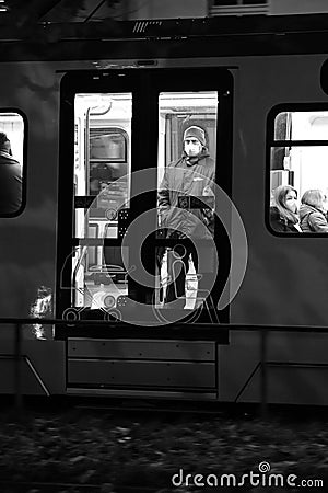 Vertical grayscale shot of people in the subway seen from the windows in Duesseldorf, Germany. Editorial Stock Photo