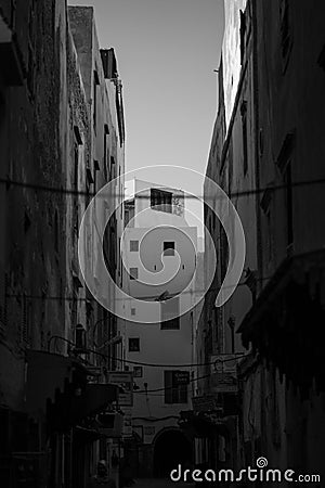 Vertical grayscale view through old buildings in medina (old town) Editorial Stock Photo