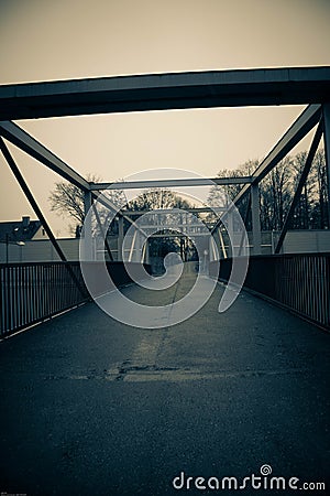 Vertical greyscale shot of a bridge captured in the streets of Munich, Germany Stock Photo