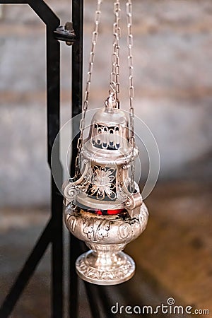 Vertical of a hanging silver incense burner. Stock Photo