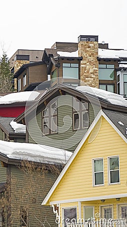 Vertical Home exteriors with horizontal wall siding and thick snow on the roofs Stock Photo