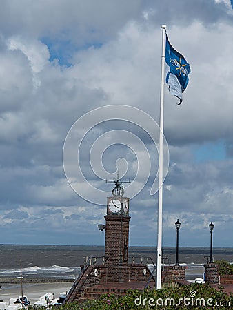 Vertical image of a clock located in the beach of the North Sea in Wangerooge, Germany Editorial Stock Photo