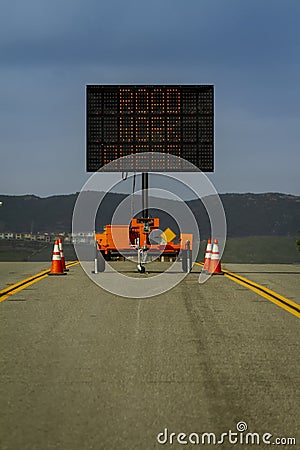Vertical image of a Digital Road Sign stating Road Work Ahead on a road Stock Photo
