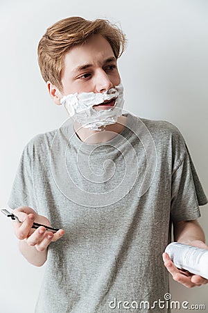 Vertical image of Incomprehensible man in shaving foam Stock Photo