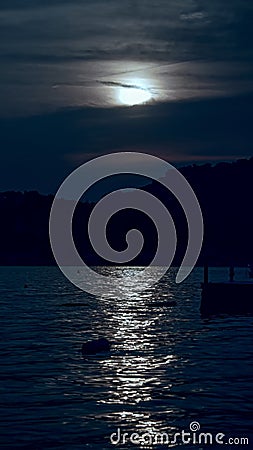Vertical image of moonpath over the sea waves. Moon shining and reflecting on ocean surface Stock Photo