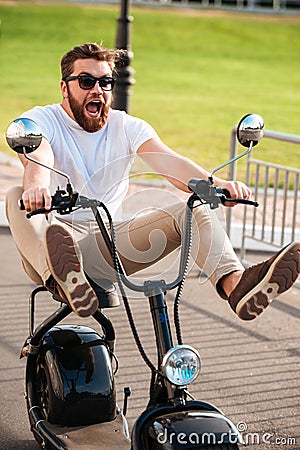 Vertical image of scared screaming bearded man in sunglasses Stock Photo