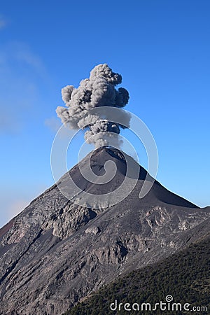 Vertical image of Smoke Column from the Chimney of Acatenango Volcano. Volcan del Fuego Erupting big black smokes in Guatemala Stock Photo