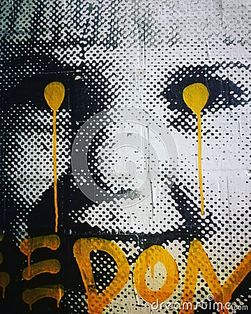 Vertical image of a street art portrait of a little girl with yellow dots in the eyes Editorial Stock Photo