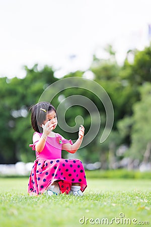 Vertical image. A young girl is stumped alone after losing a soccer match, a child sits on a soccer ball. Stock Photo