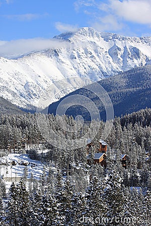 A vertical landscape image of cabins in Winter Park, Colorado. Stock Photo