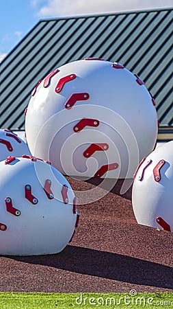 Vertical Large baseball decoration at a playground viewed on a sunny day Editorial Stock Photo