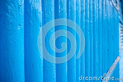 Vertical log wall in blue, outdoors. Wooden building. Stock Photo