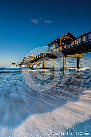 Vertical long exposure of a pier at the shore Stock Photo