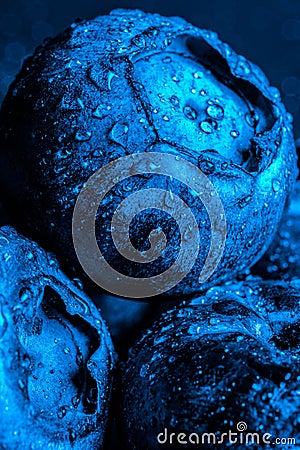 Vertical macro shot of blueberries with waterdrops on the against black background Stock Photo