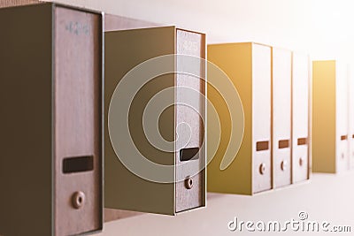 Vertical mailboxes on wall with sunlight Stock Photo