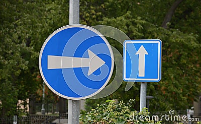 Vertical metal repair signs commanded direction of travel, one way, no entry, pedestrian zone, respirator mask dead end street in Stock Photo