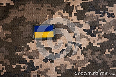 Vertical photo of banner of ukrainian flag on camouflage textile Stock Photo