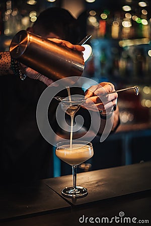 vertical photo of a cocktail being prepared at a cocktail bar by a bartender Stock Photo