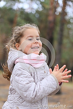 Vertical photo of a girl who claps and laughs with pleasure Stock Photo