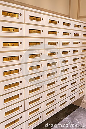 Vertical photo of letter mailboxes in postal room of condominium building Stock Photo