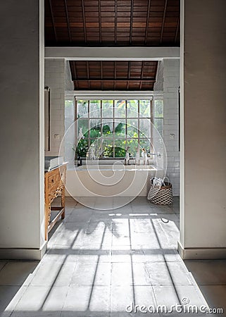 Light bathroom interior with ceramic sink on wooden table, modern decor, built bathtub Stock Photo