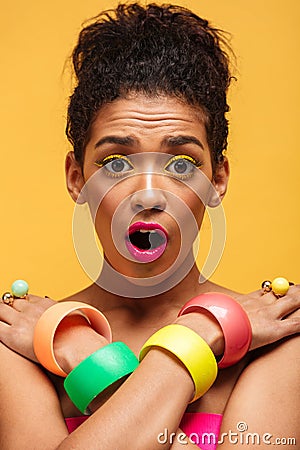 Vertical photo of surprised african woman in colorful adornment Stock Photo