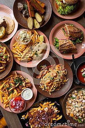 Vertical photo various of food on cafe table. Italian, american food platesm junk and snack food. Top view, full frame Stock Photo