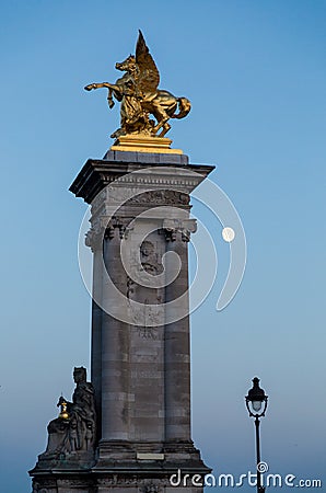 Vertical picture of the Statue of a Fame on the Pont Alexandre III in the evening in Paris, France Editorial Stock Photo