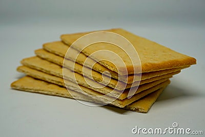 Vertical piles of crunchy crackers snacks in white background Stock Photo