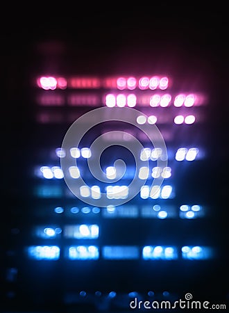 Vertical pink and purple office building illumination bokeh back Stock Photo