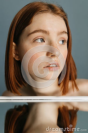 Woman looking away while sitting at the table Stock Photo