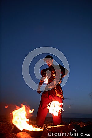 Male performer juggling fire Stock Photo