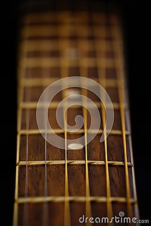 Vertical selective focus shot of strings and fretboard of acoustic guitar Stock Photo