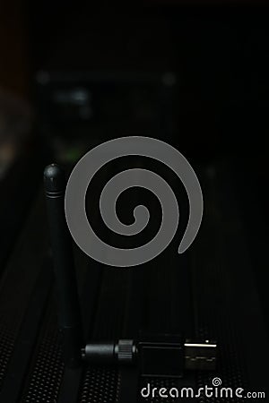 Vertical shallow focus closeup shot of a black USB Wi-Fi adapter Stock Photo
