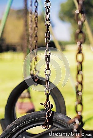 Vertical shallow focus of tire swings in a park Stock Photo