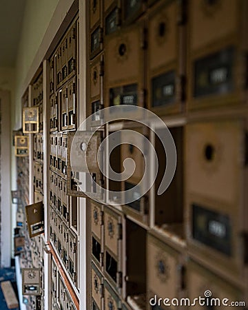 Vertical shot of abandoned mailboxes in an old post office on Adak Island Stock Photo