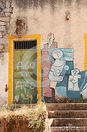 Vertical shot of an abstract creative mural of the family on the wall in Orgosolo, Italy Editorial Stock Photo