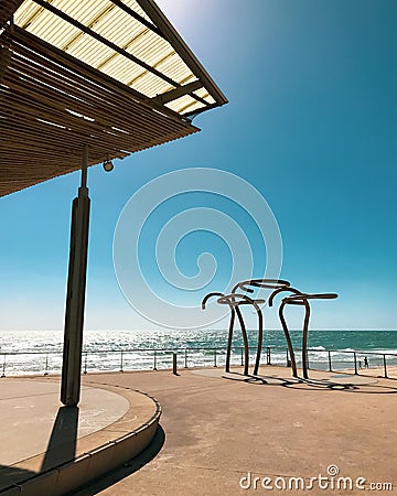 Vertical shot of an abstract sculpture on the sunny shore of Henley Beach in Australia Editorial Stock Photo