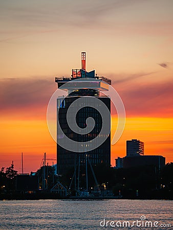 Vertical shot of Adam tower during scenic orange sunset, Amsterdam, Netherlands Stock Photo