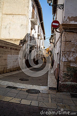 Vertical shot of an alleyway with old buildings in Xativa, Spain Stock Photo