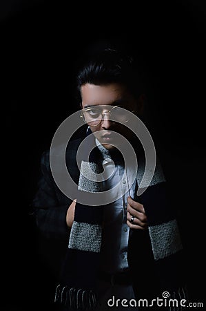 Vertical shot of an Asian male wearing glasses and a scarf Stock Photo