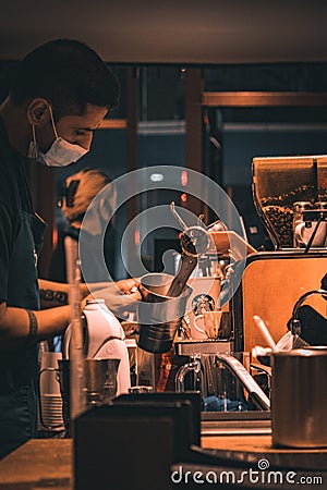 Vertical shot of the barista making coffee at Starbucks at night in Auckland, New Zealand Editorial Stock Photo