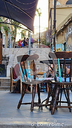 Vertical shot of the beautiful brown antique chairs of an outdoor cafe Editorial Stock Photo